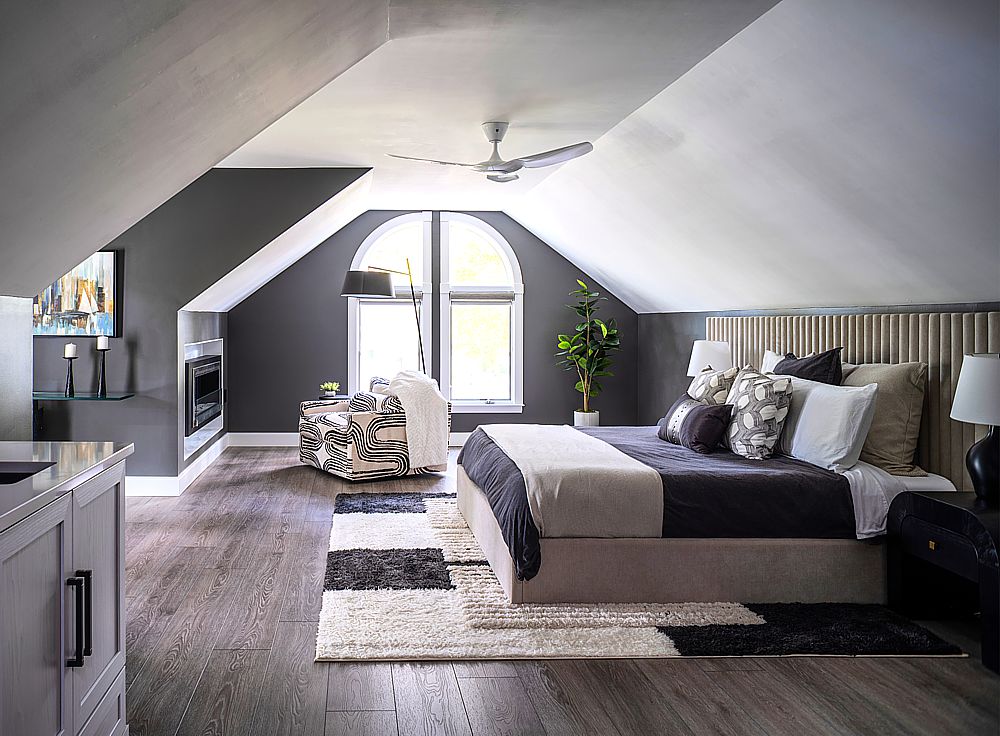 Dark walls and ceiling create a cocoon to spend nights in this luxury bedroom with a built-in contemporary fireplace and TV system.