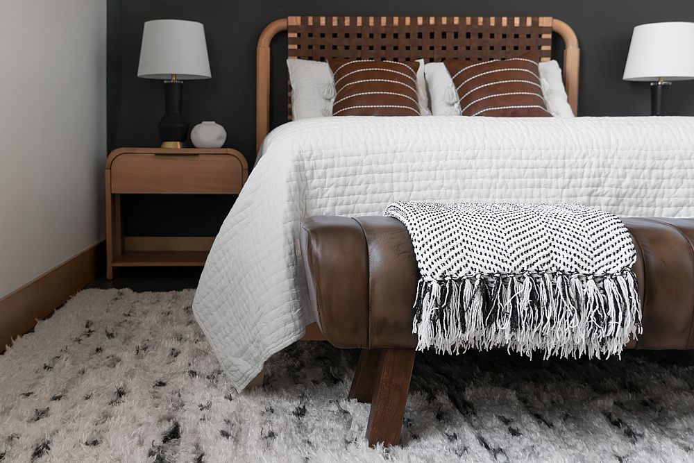 Dark walls contrast with white in this loft bedroom.